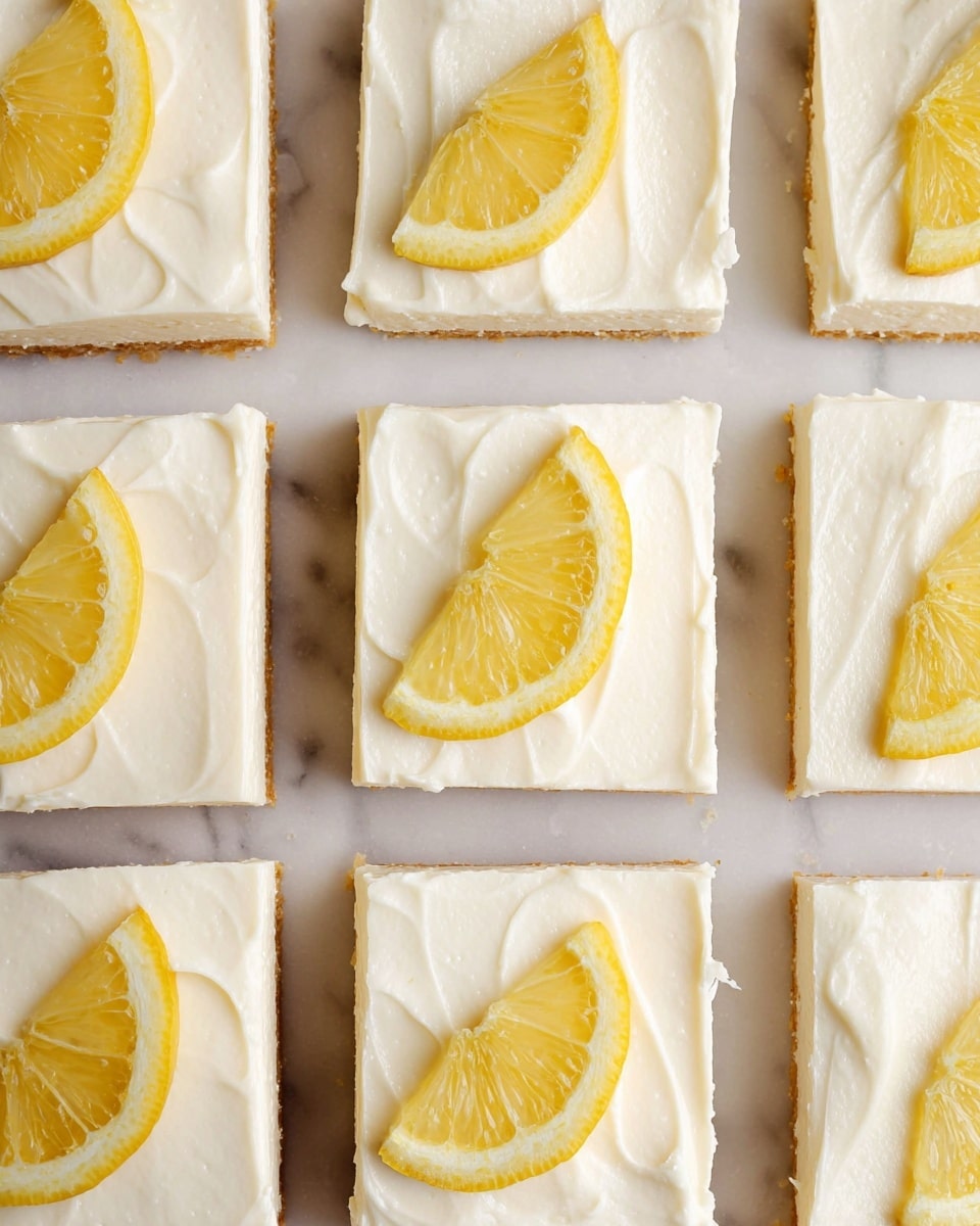 This image shows a tray of lemon dessert squares arranged in a 3 by 4 grid on a white marbled surface. Each square has three visible layers: a thin golden brown base, a thick creamy white middle layer, and a smooth white frosting on top with delicate swirl textures. Each square is decorated with a single thin lemon slice placed in the upper left corner, showing bright yellow color and translucent detail. The disorder of the spreads and texture on the frosting layer creates a fresh, homemade look. The photo taken with an iphone --ar 4:5 --v 7