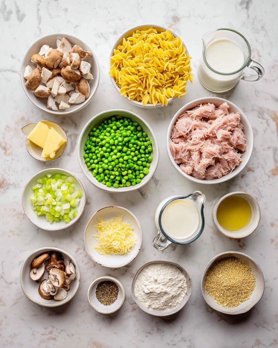 The image shows many ingredients placed in white bowls and a small glass pitcher on a white marbled surface. There are yellow twisted noodles in one bowl, light pink chunks of tuna in another, and bright green peas in a different bowl. Diced white onions and chopped celery are also in separate white bowls. Small bowls hold sliced brown mushrooms, light brown dry breadcrumbs, and a mix of salt, black pepper, and other spices. There are small pieces of yellow butter, a small bowl of lemon zest, a small bowl of oil, flour in a bowl, and a glass pitcher filled with white cream. The ingredients are neatly arranged in rows across the surface. photo taken with an iphone --ar 4:5 --v 7