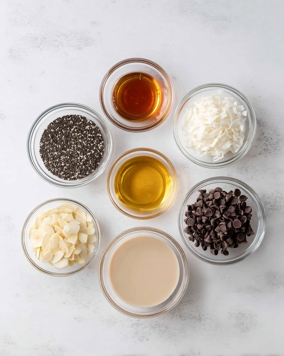 Seven clear glass bowls with different ingredients are arranged on a white marbled surface. The largest bowl at the bottom right contains a smooth, light beige liquid. To the left of it is a smaller bowl filled with tiny black and white chia seeds. Above the chia seeds is a small bowl with a dark amber liquid. A larger bowl in the middle holds a golden brown syrup. To its right is a bowl filled with white, thin coconut flakes. Above that is a bowl with small dark brown chocolate chips. To the left of the chocolate chips is a bowl containing light cream-colored sliced almonds. The bowls are evenly spaced, and the overall scene is bright and clean. photo taken with an iphone --ar 4:5 --v 7
