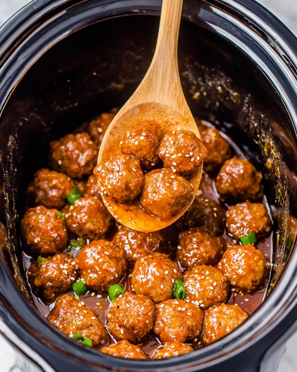 The image shows many small, round meatballs with a shiny orange-brown sauce inside a black slow cooker. The meatballs have a slightly textured surface and are mixed with small pieces of green onion and white sesame seeds, scattered evenly across them. A wooden spoon lifts a few meatballs above the rest, showing their round shape and glossiness from the sauce. The inside of the slow cooker has traces of sauce on the sides, adding depth to the dish. The background is a white marbled texture. photo taken with an iphone --ar 4:5 --v 7