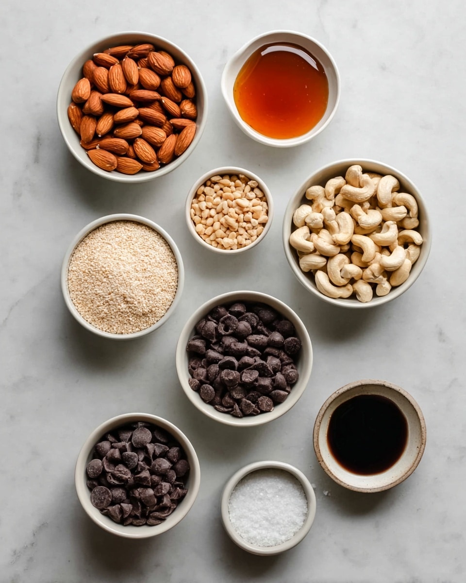 The image shows eight small white bowls arranged on a white marbled surface, each containing different ingredients. Starting from the top left, one bowl is filled with whole almonds in a deep orange-brown color. To its right, a bowl has a thick amber-colored syrup. Below the almonds, another bowl holds light brown peanuts, some with skins. Next to it on the right is a bowl filled with pale beige cashews. Below the peanuts is a bowl of off-white puffed crisp cereal. To the right of the cereal is a bowl with dark brown chocolate chips. Below the chocolate chips are two smaller bowls; one has a light beige powder or granules, and the other contains a very dark brown liquid. Another small bowl near these contains coarse white salt. All bowls are placed neatly on the smooth white marbled surface, and the photo was taken with an iphone --ar 4:5 --v 7
