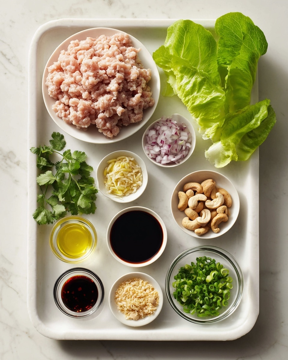 A white plastic tray holds a layer of pale pink ground chicken with a slightly textured surface, placed on the top left. To the right, small white bowls arranged in a loose cluster contain finely chopped pale purple shallots, light yellow minced lemongrass, and light brown cashews with a smooth texture. Below these, a small brown bowl of light yellow garlic and a dark thick hoisin sauce in a white bowl are seen. A small glass bowl holds a clear pale yellow oil, while next to it, a small glass bowl with a dark soy sauce and a small dark red garlic chili sauce stand side by side. To the left, a small white bowl with chopped green cilantro leaves sits near a few unwrapped, vibrant green butter lettuce leaves placed on a white marbled surface. Lastly, a small white bowl filled with bright green chopped green onions completes the arrangement. Photo taken with an iphone --ar 4:5 --v 7