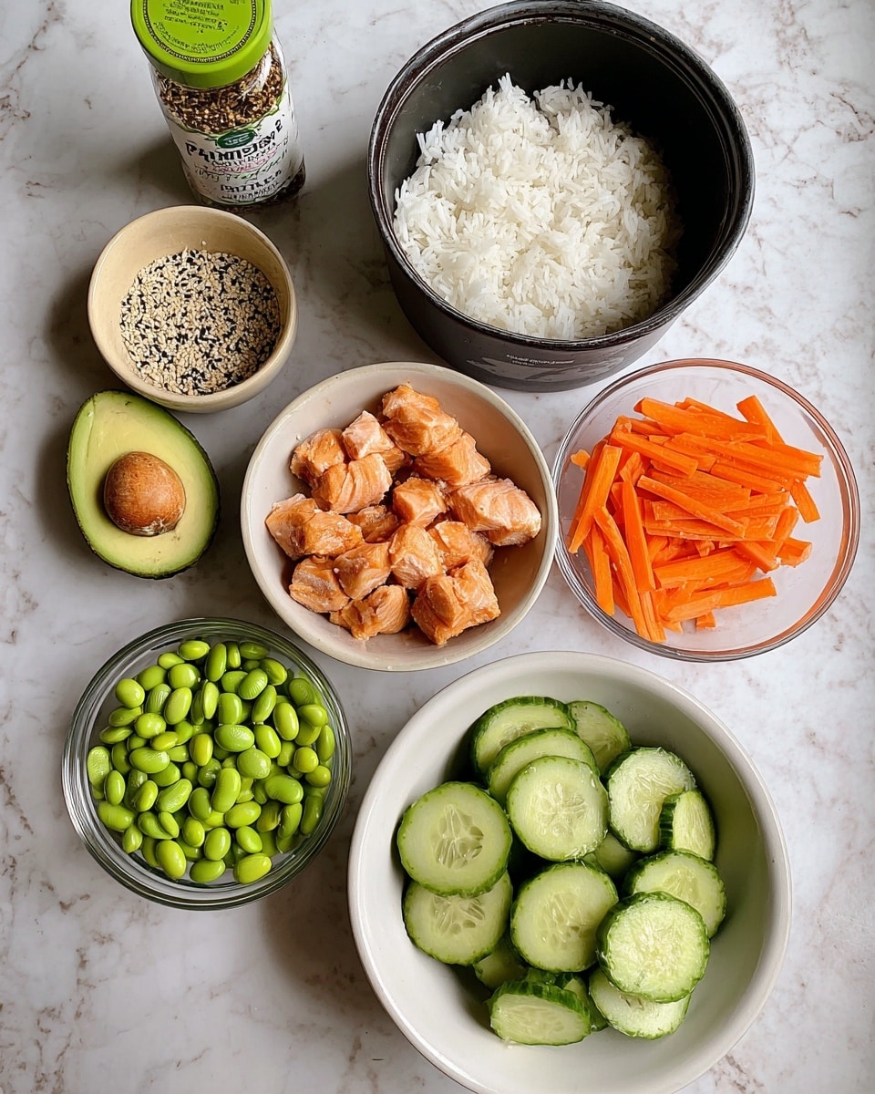 The image shows six separate white bowls and a black pot arranged on a white marbled surface. Starting from the top right, a black pot is filled with white steamed rice. Below the pot, a white bowl contains small chunks of cooked, lightly brown salmon. To the right and slightly below is a white bowl filled with round, thinly sliced cucumber pieces, showing a fresh green and slightly shiny texture. Below and to the left is a halved avocado with a green outer skin and light green flesh around a brown seed. Above the avocado, a white bowl holds thin orange carrot sticks. Above and slightly right is a clear glass bowl with bright green shelled edamame beans. At the top left, there is a small beige bowl with a mix of black and white sesame seeds, and next to it is a glass spice jar labeled