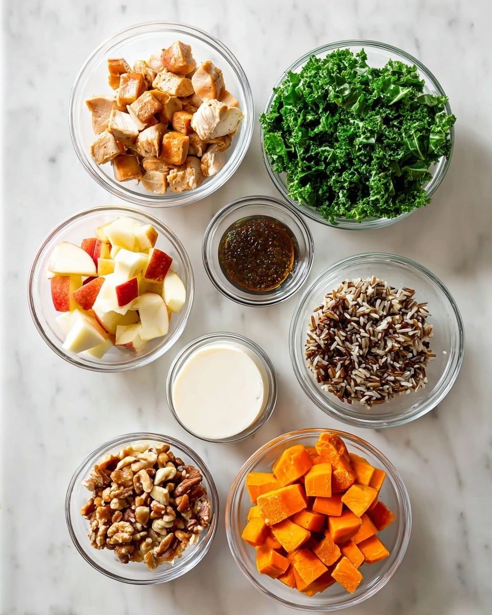 The image shows seven small clear glass bowls arranged on a white marbled surface. Starting from top left and moving clockwise: the first bowl contains light brown cooked chicken pieces that are cubed; next to it is a bowl filled with bright green fresh kale leaves; below that is a bowl with a dark brown, slightly thick sauce; next is a bowl with a mix of cooked wild rice, featuring brown and black grains; below that is a bowl holding a smooth, white round block of cheese. To the left of this cheese bowl is a bowl filled with small apple cubes showing red skin and pale yellow flesh, and above it is a bowl with medium orange roasted sweet potato chunks. Another bowl in the lower left contains a mix of chopped almonds and nuts. Each ingredient has its own bowl, all placed neatly with clear visibility. photo taken with an iphone --ar 4:5 --v 7
