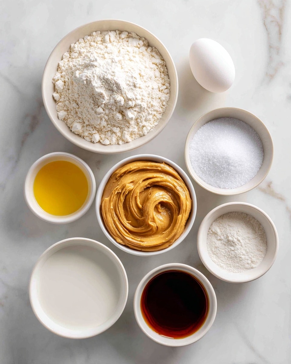 The image shows nine white bowls and one white egg placed on a white marbled surface. The largest bowl at the top left holds white all-purpose flour with a slightly uneven surface. Below it, a medium bowl contains white granulated sugar with a smooth top. To the right of the sugar, a smaller bowl has creamy peanut butter with a thick, smooth texture and swirled peaks. Above the peanut butter, a small bowl contains golden-yellow vegetable oil with a shiny surface. Next to the oil, a medium bowl is filled with white milk, smooth and flat on top. Above the milk, a small bowl holds dark brown vanilla extract with a liquid surface. To the right of the vanilla, a smaller bowl contains white baking powder, baking soda, and salt mixed together with a powdery texture. At the top right corner, a single white egg sits on the marble surface. photo taken with an iphone --ar 4:5 --v 7