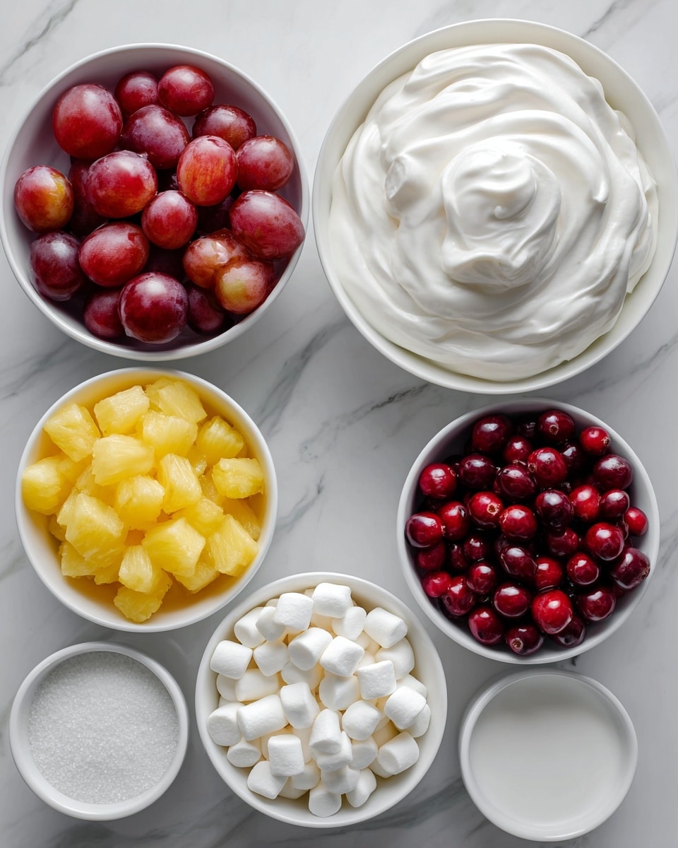 Six white bowls are arranged on a white marbled surface. The top left bowl holds halved red grapes showing a mix of shiny red and purple colors with a smooth, juicy texture. To its right, a larger white bowl is filled with smooth, fluffy white cool whip with a soft peak in the center. Below the grapes, another white bowl contains small, bright yellow pineapple tidbits with a slightly wet texture. To the right of the pineapple, a white bowl is filled with round, shiny, deep red cranberries that look fresh and firm. Below the grapes and pineapple, a white bowl contains small, white mini marshmallows, soft and puffy. To the right of the mini marshmallows, the last white bowl is filled with fine, pure white sugar, smooth and granular. Photo taken with an iphone --ar 4:5 --v 7