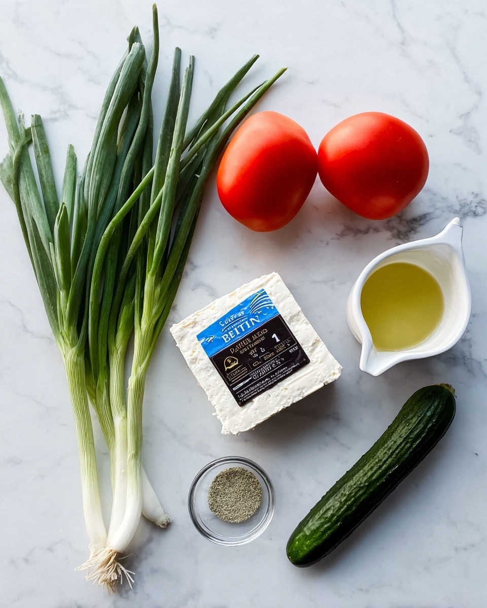 The image shows fresh green onions with long green leaves and white roots on the left side, resting on a white marbled surface. Next to them is a block of white feta cheese wrapped with a blue and black label. Above the cheese are two red Roma tomatoes with smooth skin. To the right of the tomatoes, there is a white measuring cup filled with a light yellow liquid, marked 1/4 cup. Below the cup, there is a small clear glass bowl containing a light gray ground spice. Finally, a dark green cucumber with a textured skin lies diagonally near the bottom right. The photo was taken with an iphone --ar 4:5 --v 7