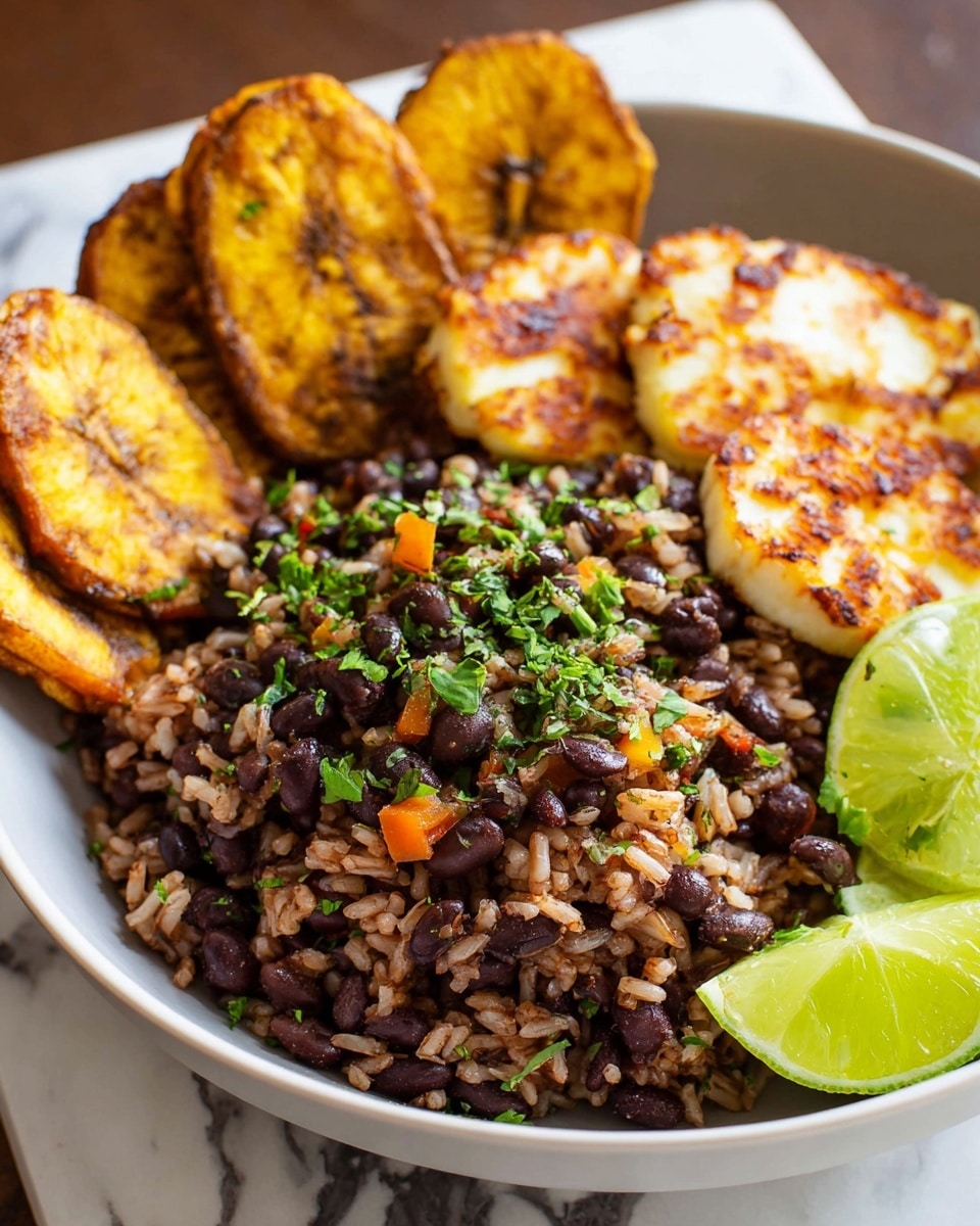 A white bowl filled with three main layers: the bottom layer is a mix of brown rice and black beans with small pieces of orange pepper and fresh green chopped herbs sprinkled on top; behind it, there are several large fried plantain slices, golden brown and slightly shiny, arranged leaning against the rice and beans; in front, there are two pieces of white cheese with golden brown seared edges, placed next to a few slices of green avocado on the right side, alongside lime halves with bright green flesh, all set on a white marbled surface. Photo taken with an iphone --ar 4:5 --v 7