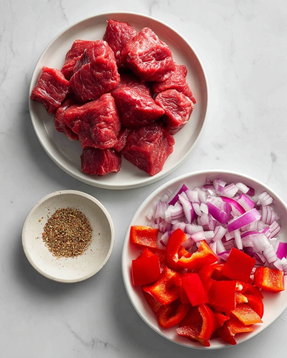 The image shows three white plates on a white marbled surface. On the left, a round plate holds several pieces of raw beef with a deep red color and a slightly shiny texture. Below it, a small white dish contains coarse, brownish Montreal steak seasoning. On the right, a larger round plate is filled with roughly chopped red onions and bright red bell pepper pieces. The onions have a smooth, shiny texture with layers visible, while the bell peppers are crisp with a glossy surface. The arrangement is clean and simple, with natural lighting highlighting the fresh colors of the ingredients. Photo taken with an iphone --ar 4:5 --v 7