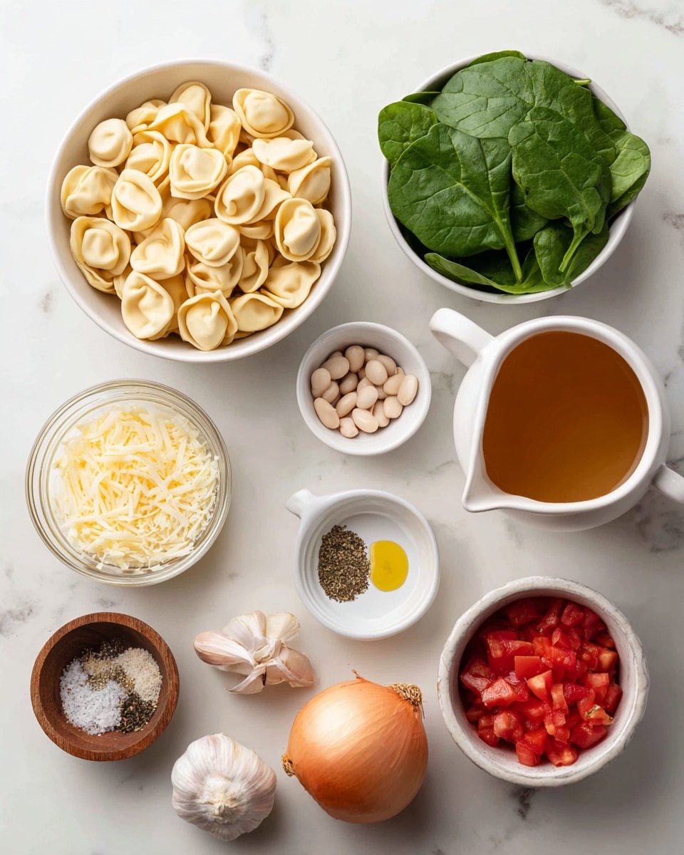 A top view of several white bowls and small clear containers arranged on a white marbled surface, each holding different ingredients for a recipe: the largest white bowl is filled with beige tortellini pasta, a medium white bowl contains fresh bright green baby spinach leaves, another white bowl holds light yellow Parmesan cheese shavings, and a white bowl shaped like a small pitcher has white beans. Small white bowls contain dried oregano flakes, peeled garlic cloves, and golden olive oil. A clear glass cup is filled with light brown broth, and there is a whole yellow onion nearby. Additionally, a small wooden bowl holds kosher salt and black pepper, and a metal cup contains bright red diced tomatoes. All items are well spaced and clearly visible, photo taken with an iphone --ar 4:5 --v 7