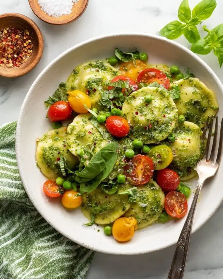Pesto Ravioli with Cherry Tomatoes, Peas, and Fresh Basil Recipe