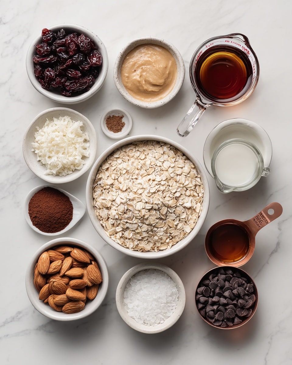 The image shows various baking ingredients arranged neatly on a white marbled surface. In the center is a large white bowl filled with light beige rolled oats. Surrounding it are smaller white bowls and measuring cups holding different items: dark red dried cherries, creamy light brown almond butter, white coconut flakes, and a clear liquid in a white cup labeled coconut oil. There is also a glass measuring cup with dark amber maple syrup, a small cup with rich brown cocoa powder, a small cup with clear water, a black measuring cup filled with whole almonds, and a copper measuring cup filled with small dark brown chocolate chips. Each ingredient is labeled with a block of text making it easy to identify. photo taken with an iphone --ar 4:5 --v 7