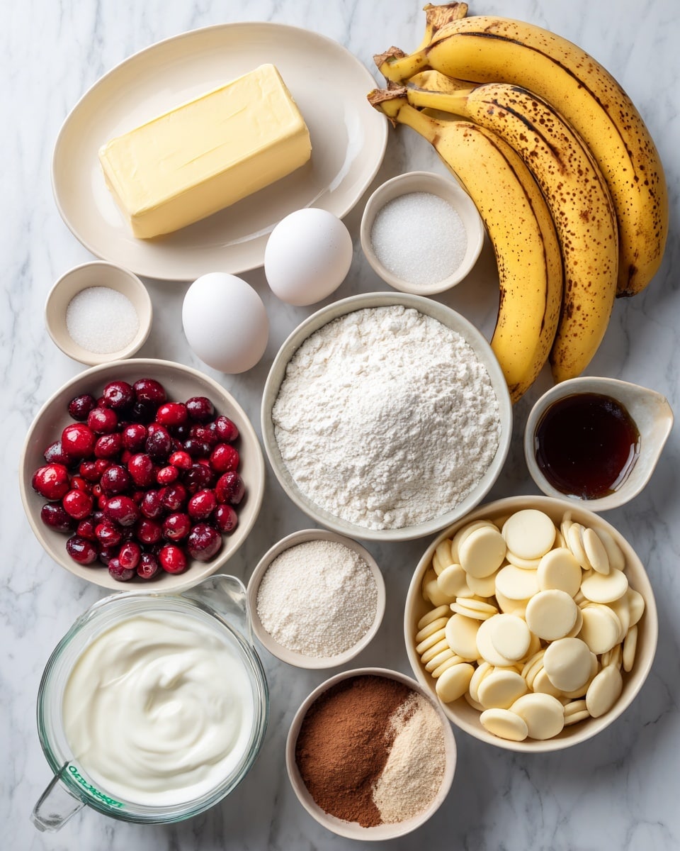 The image shows various baking ingredients arranged neatly on a white marbled surface. There are ripe bananas with yellow and brown spots placed near the center top, a stick of pale yellow butter on a white plate to the left, and two white eggs next to small bowls filled with fine white powdered sugar and vibrant red cranberries. Also visible are a small container of white sour cream, a bowl of white flour, a mix of white and light brown sugars in a white bowl, and a round dish holding white chocolate discs. A small beige plate contains white and brown powders, labeled as cinnamon and baking soda, while a clear measuring cup with heavy cream sits near the bottom. A small container with dark vanilla extract is also present. photo taken with an iphone --ar 4:5 --v 7